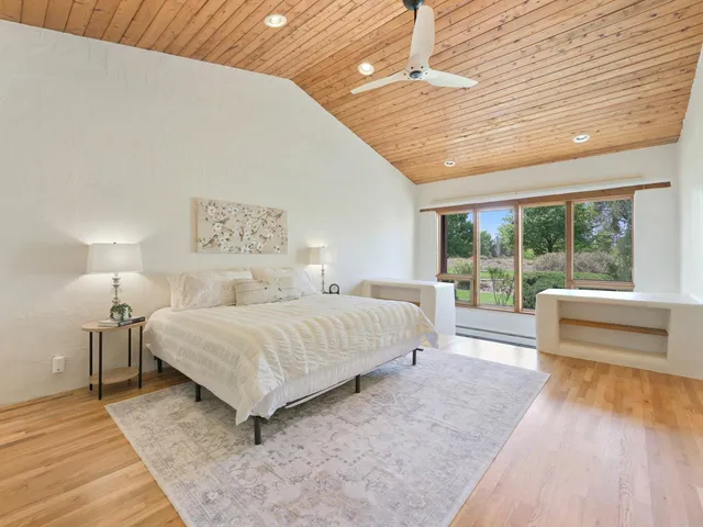 a spacious bedroom with a bed and a large window