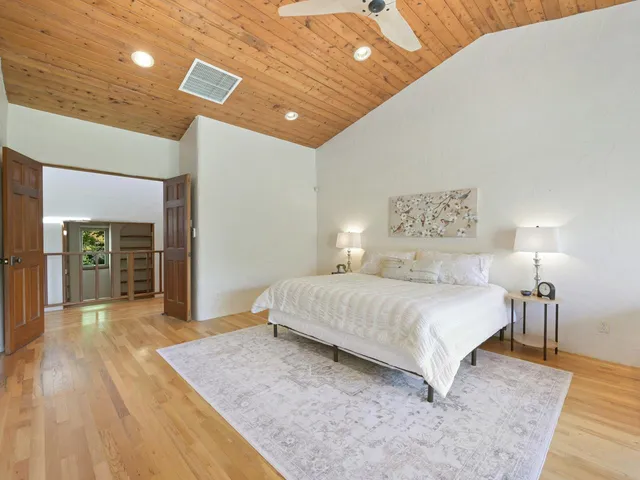 a spacious bedroom with a bed and a table