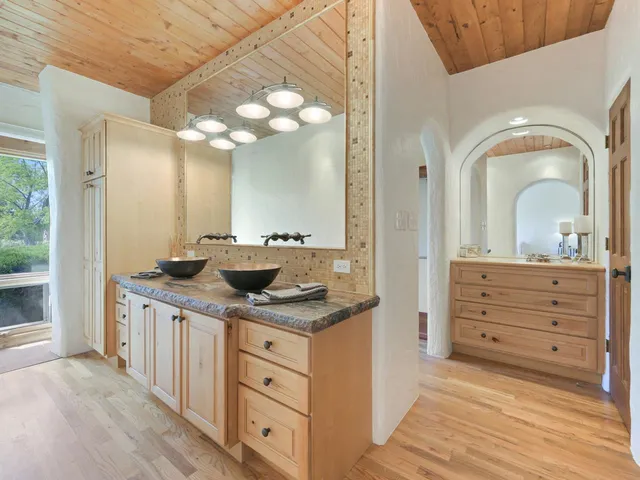 a bathroom with a granite countertop sink a mirror and a