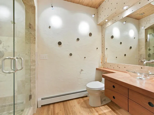 a bathroom with a double vanity sink toilet mirror and shower