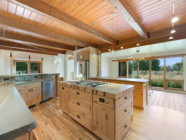 a spacious bathroom with a granite countertop sink and a large window