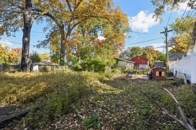 a front view of house with yard and trees around
