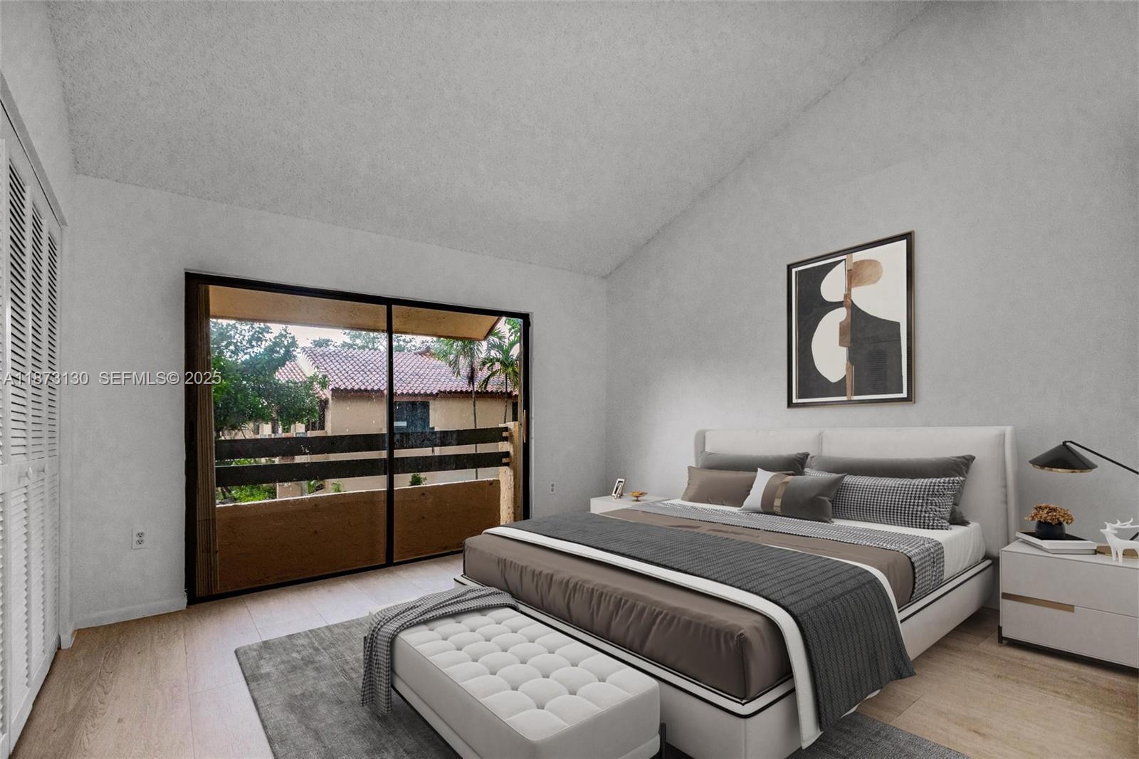 7820 Southwest 102nd Lane Miami, FL 33156 - Photo 20 of 31 a bedroom with a balcony a bed and a large window
