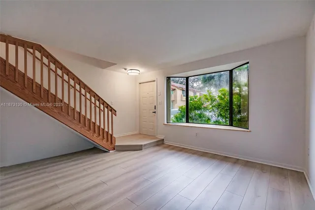 a view of an entryway with wooden floor and windows