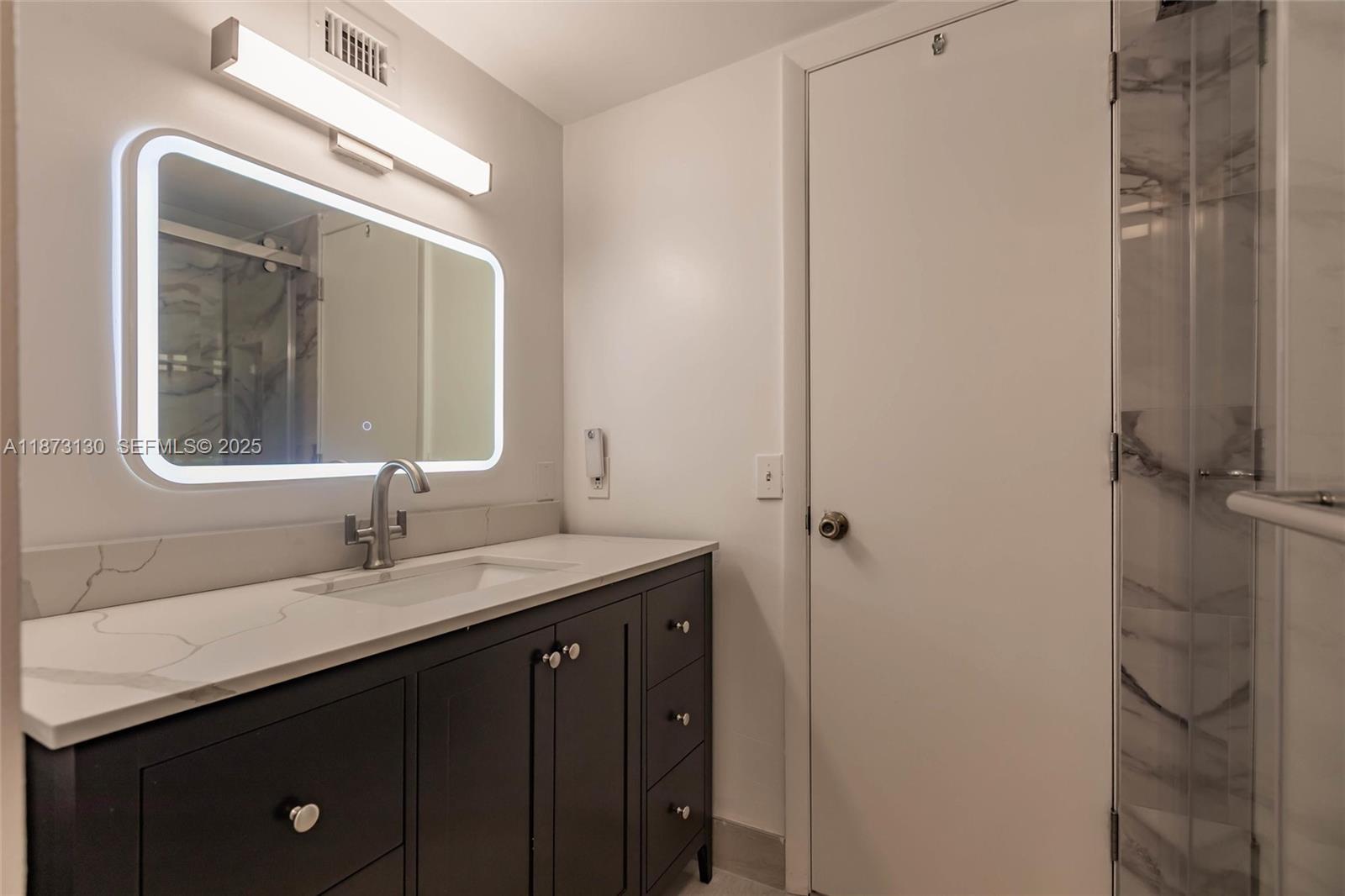 7820 Southwest 102nd Lane Miami, FL 33156 - Photo 21 of 31 a bathroom with a double vanity sink and mirror