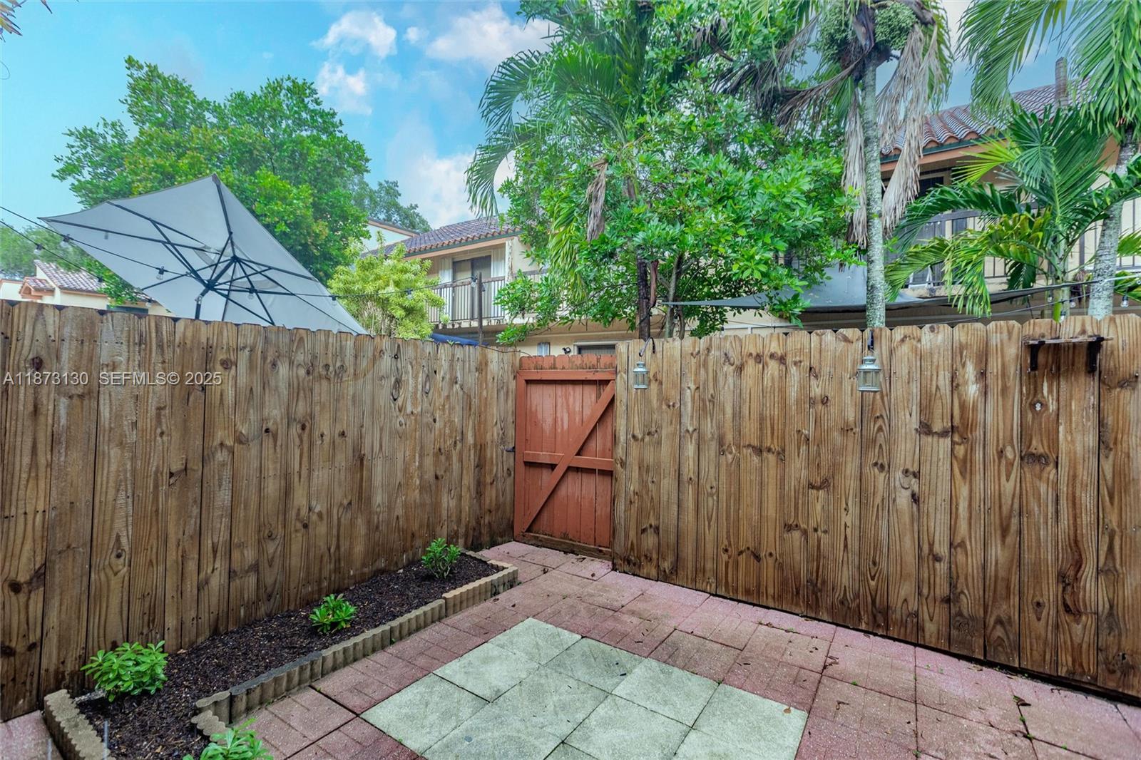 7820 Southwest 102nd Lane Miami, FL 33156 - Photo 24 of 31 a view of a backyard with wooden fence