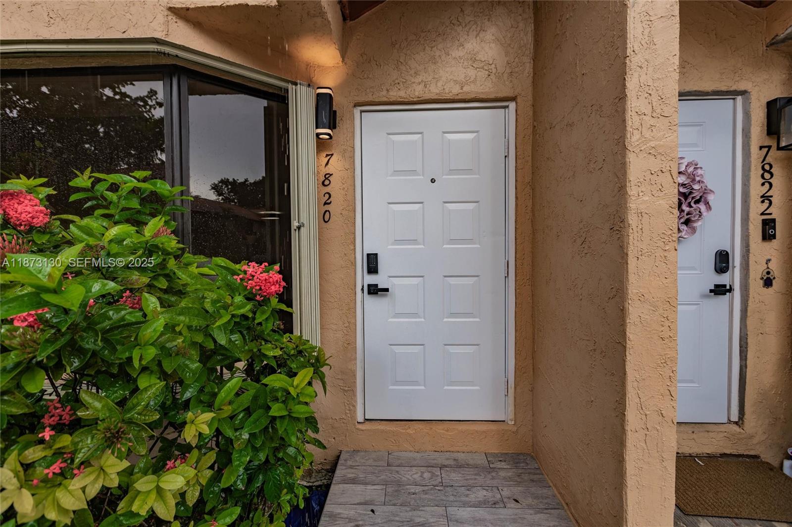 7820 Southwest 102nd Lane Miami, FL 33156 - Photo 25 of 31 front view of a house with a potted plant
