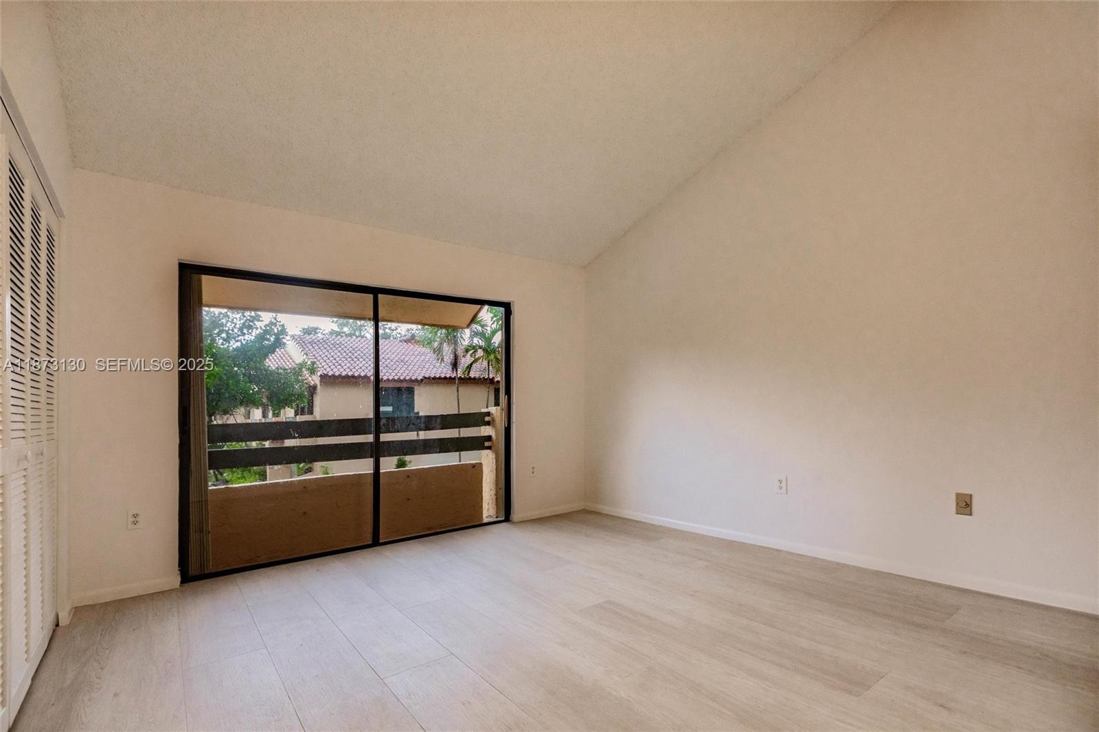 7820 Southwest 102nd Lane Miami, FL 33156 - Photo 4 of 31 an empty room with wooden floor and windows