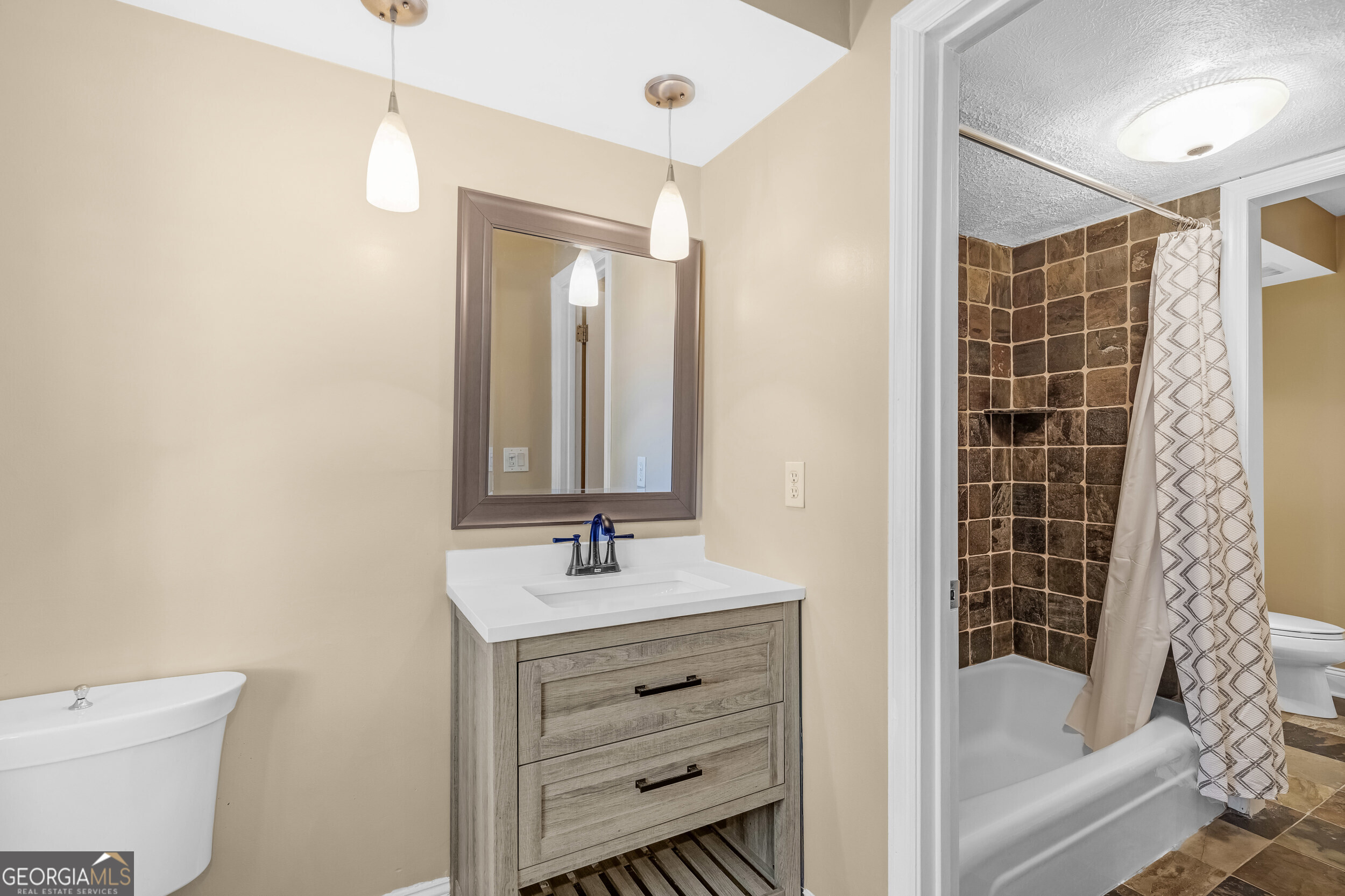 3091 Colonial Way Atlanta, GA 30341 - Photo 16 of 26 a bathroom with a bathtub shower sink vanity and toilet