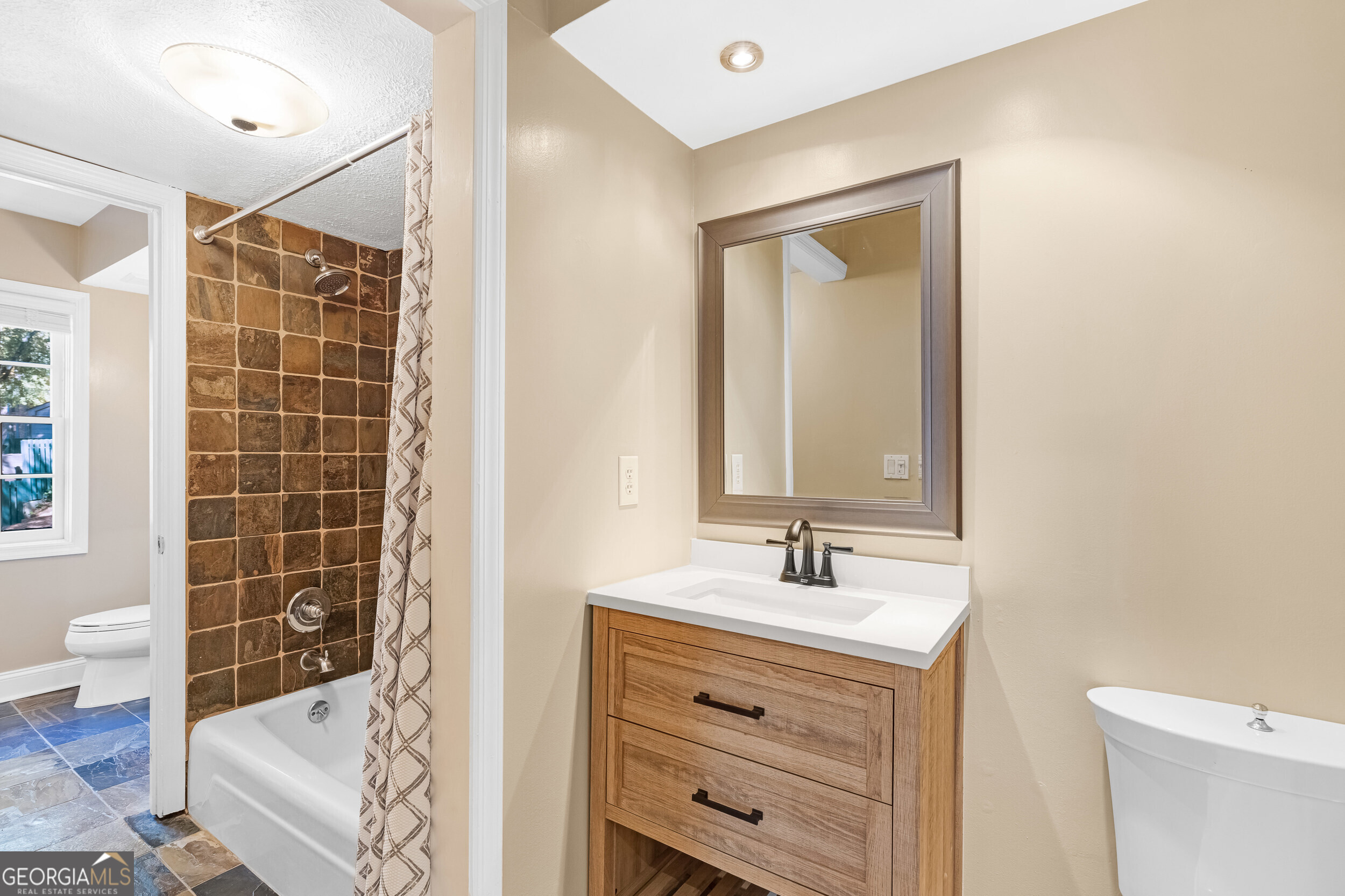 3091 Colonial Way Atlanta, GA 30341 - Photo 18 of 26 a bathroom with a sink mirror and shower