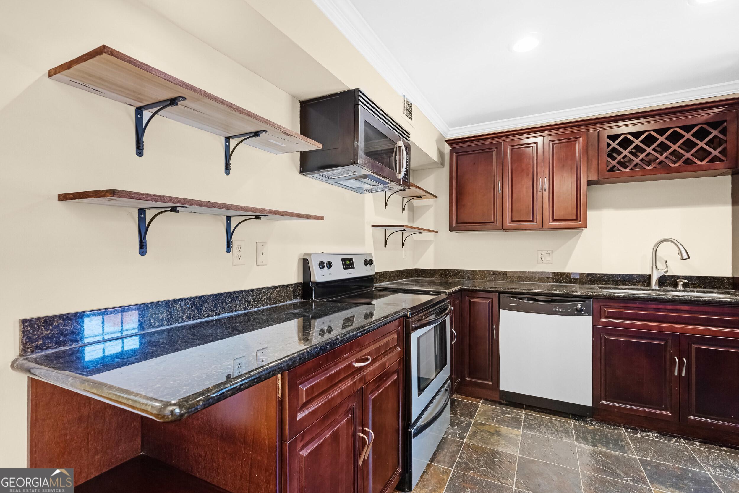 3091 Colonial Way Atlanta, GA 30341 - Photo 4 of 26 a kitchen with stainless steel appliances granite countertop a sink and stove