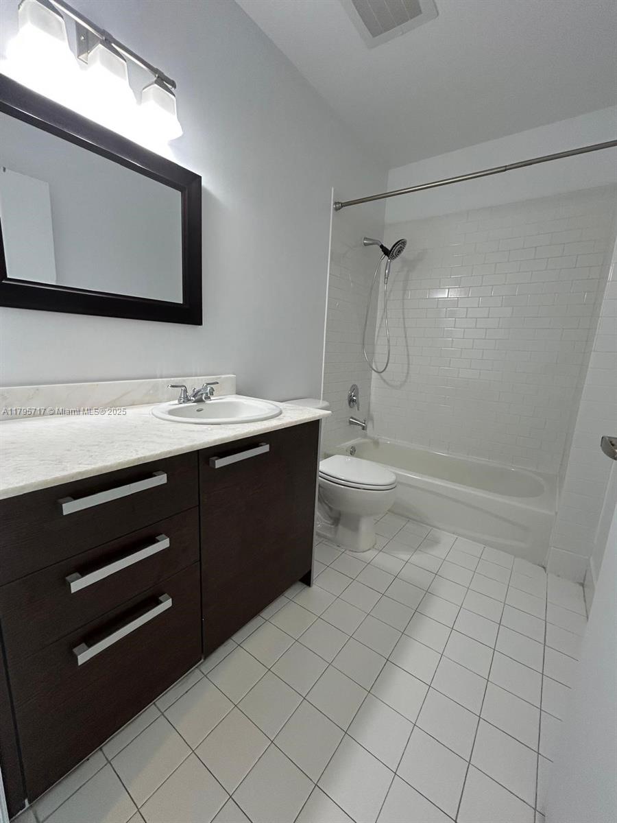 2525 Southwest 3rd Avenue, Unit 1402 Miami, FL 33129 - Photo 18 of 37 a bathroom with a sink a toilet and mirror