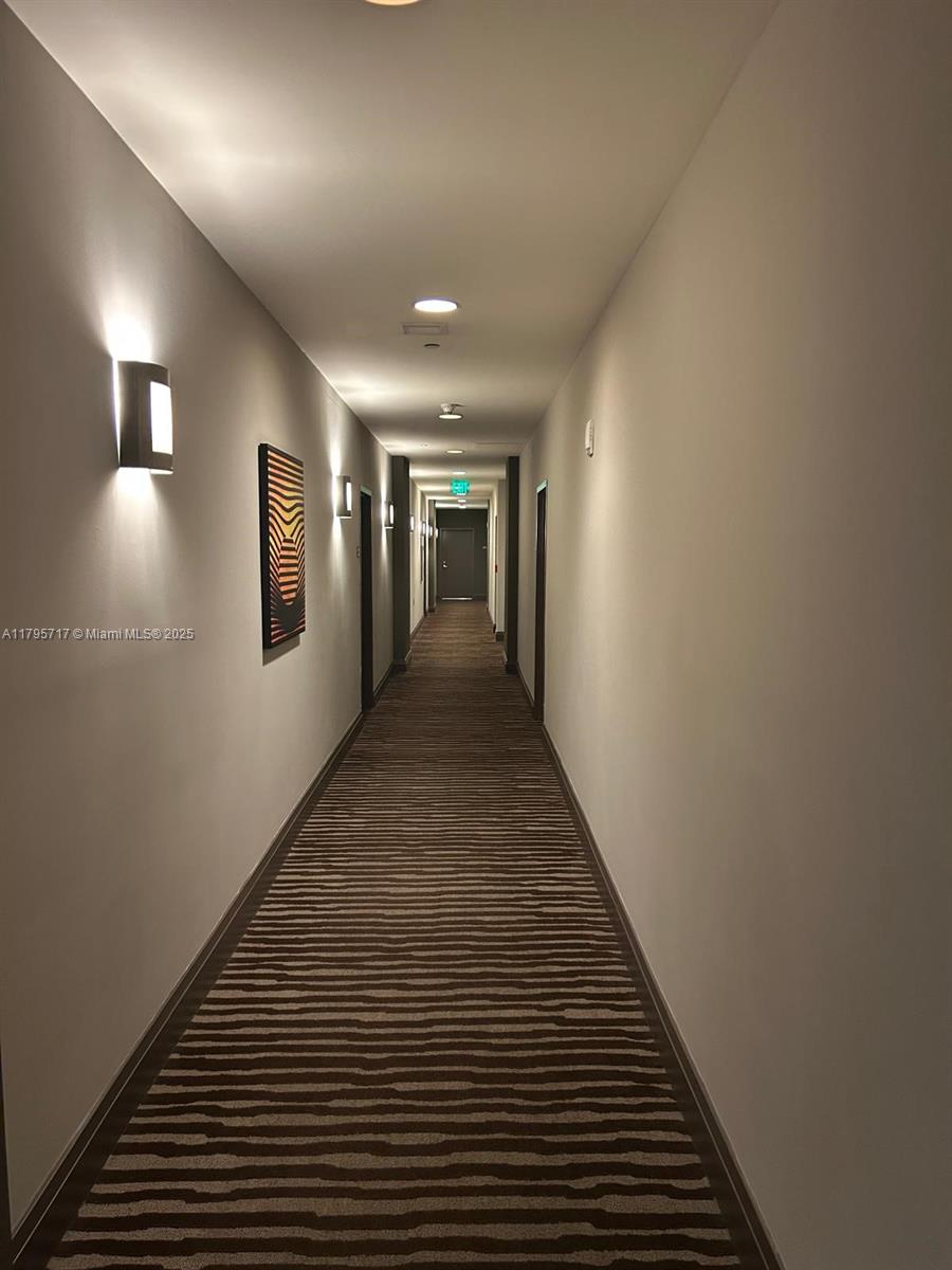 2525 Southwest 3rd Avenue, Unit 1402 Miami, FL 33129 - Photo 27 of 37 a view of a hallway with wooden floor