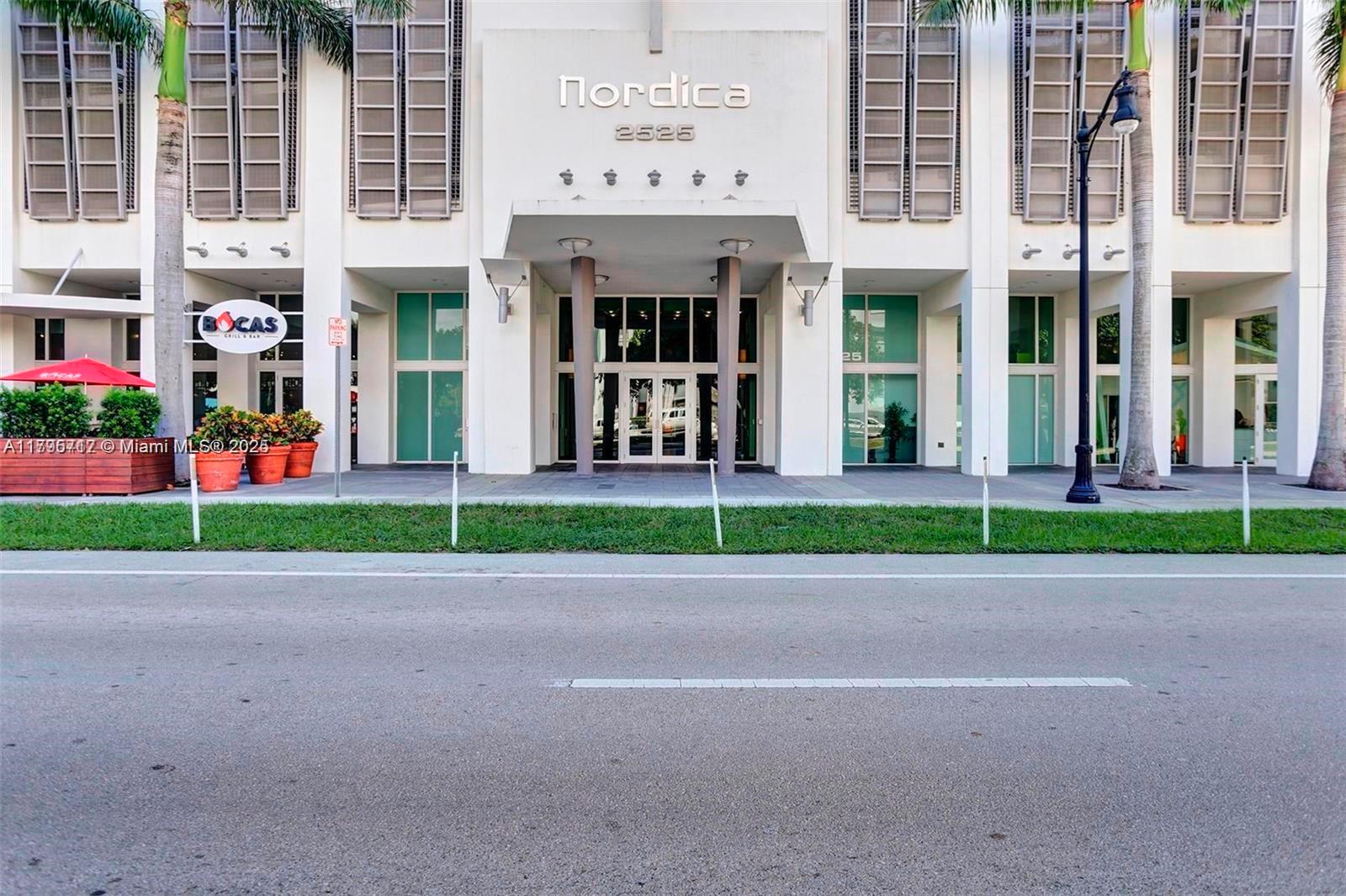 2525 Southwest 3rd Avenue, Unit 1402 Miami, FL 33129 - Photo 6 of 37 a view of a brick building with a yard in front of it