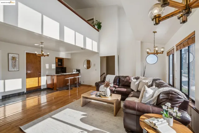 a living room with furniture kitchen view and a window