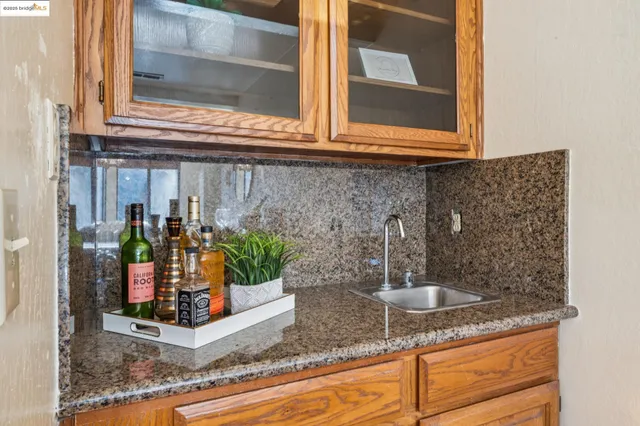 a kitchen with granite countertop a sink and a window