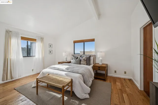 a bedroom with a bed and wooden floor