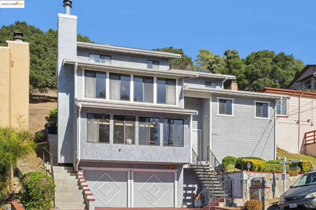 a large building with a large window and wooden fence