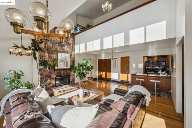 a living room with furniture a chandelier and a flat screen tv
