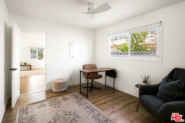 a living room with furniture a rug and a window