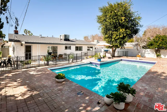 a front view of a house with a garden and sitting area