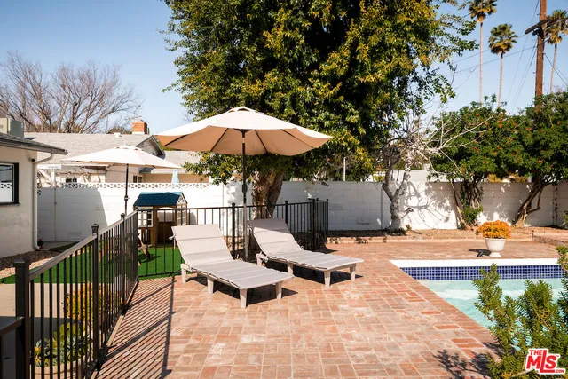 a view of a backyard with sitting area and furniture