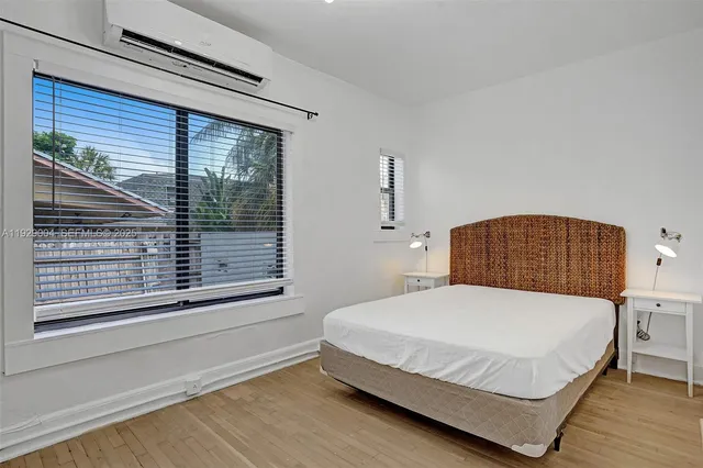 a bedroom with a bed lamps and a chandelier