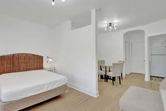 a bedroom with a bed and a couch