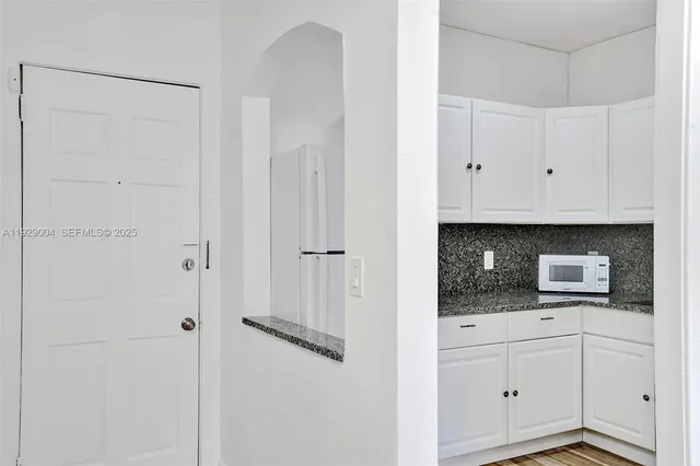 a bathroom with a sink toilet vanity and bathtub