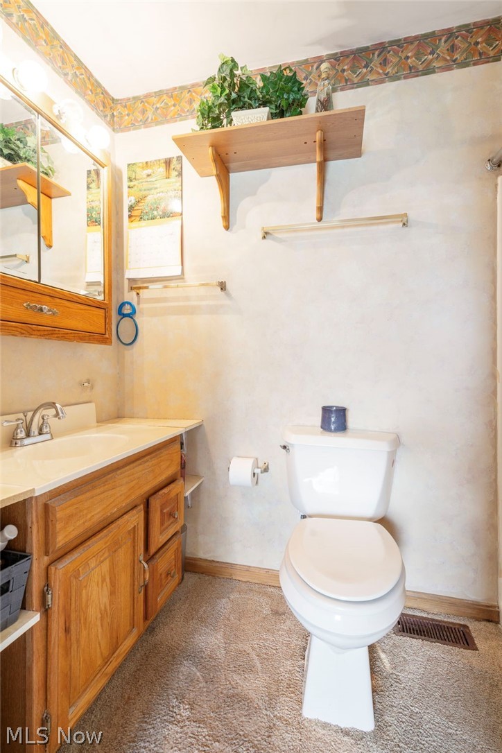 1850 South Sawburg Road Alliance, OH 44601 - Photo 17 of 39 First floor master bathroom featuring toilet, vanity with extensive cabinet space and walk in shower