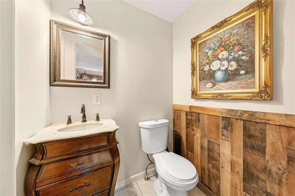 a bathroom with a toilet a sink and a mirror