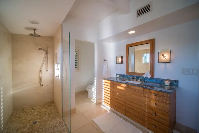 a spacious bathroom with a granite countertop sink and a mirror