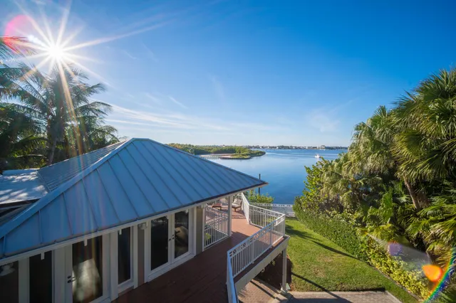 a view of a balcony with wooden floor and lake view