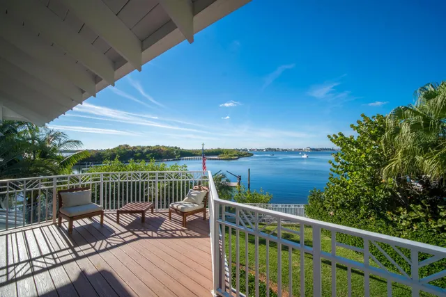 a view of a balcony with wooden floor and fence