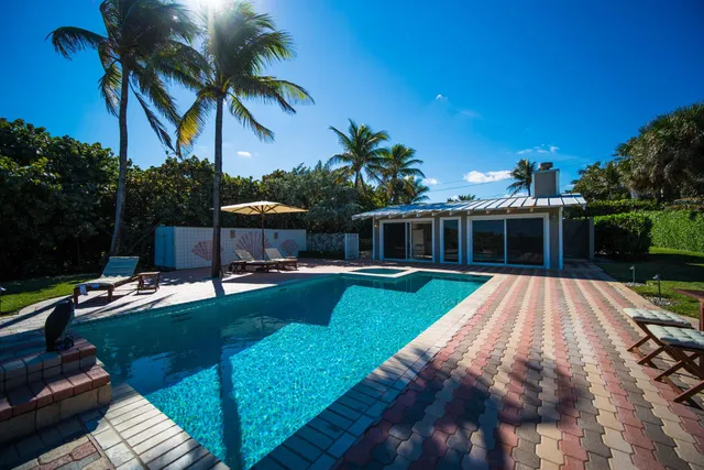 a view of a house with swimming pool and a yard