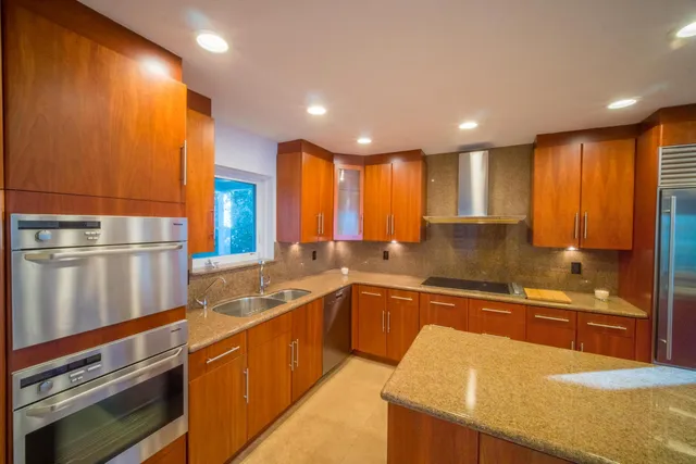 a large kitchen with lots of counter space and a sink