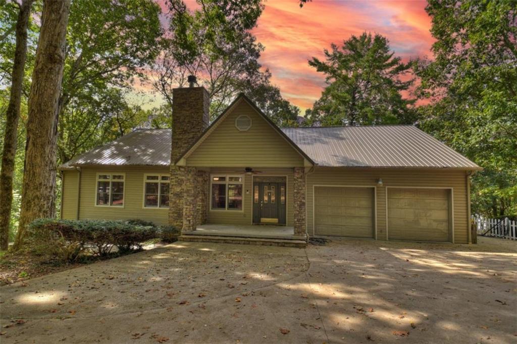 293 Turkey Creek Road Ellijay, GA 30536 - Photo 1 of 1 a front view of a house with a garden