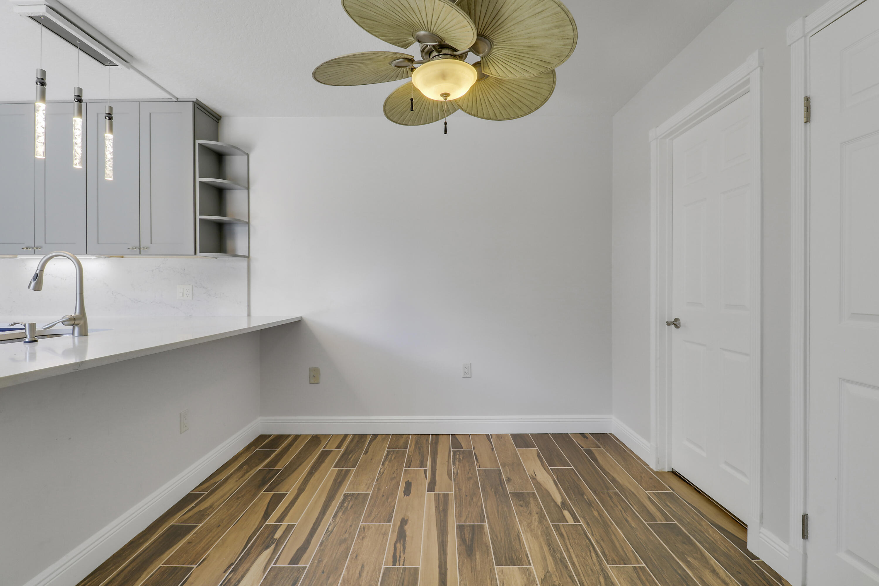2324 23rd Court, Unit 55D Jupiter, FL 33477 - Photo 11 of 41 a view of an empty room with wooden floor and a window