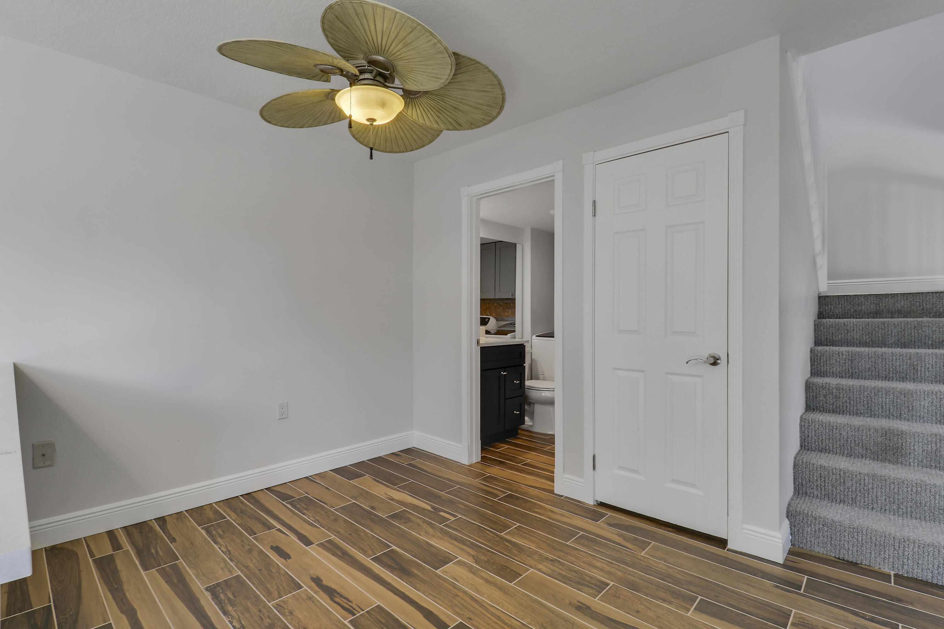 2324 23rd Court, Unit 55D Jupiter, FL 33477 - Photo 12 of 41 a view of room with wooden floor