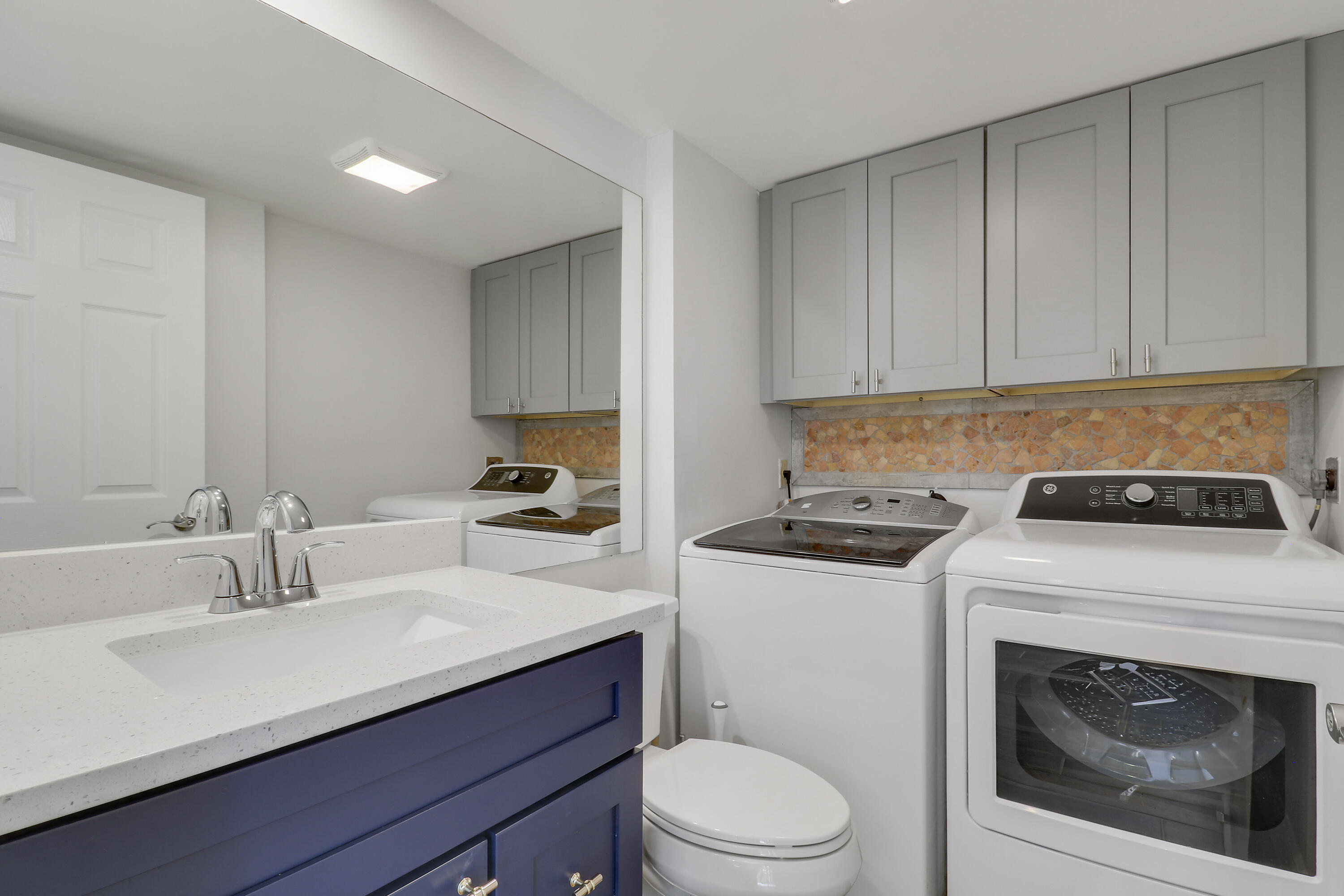 2324 23rd Court, Unit 55D Jupiter, FL 33477 - Photo 14 of 41 a kitchen with a sink stove and cabinets