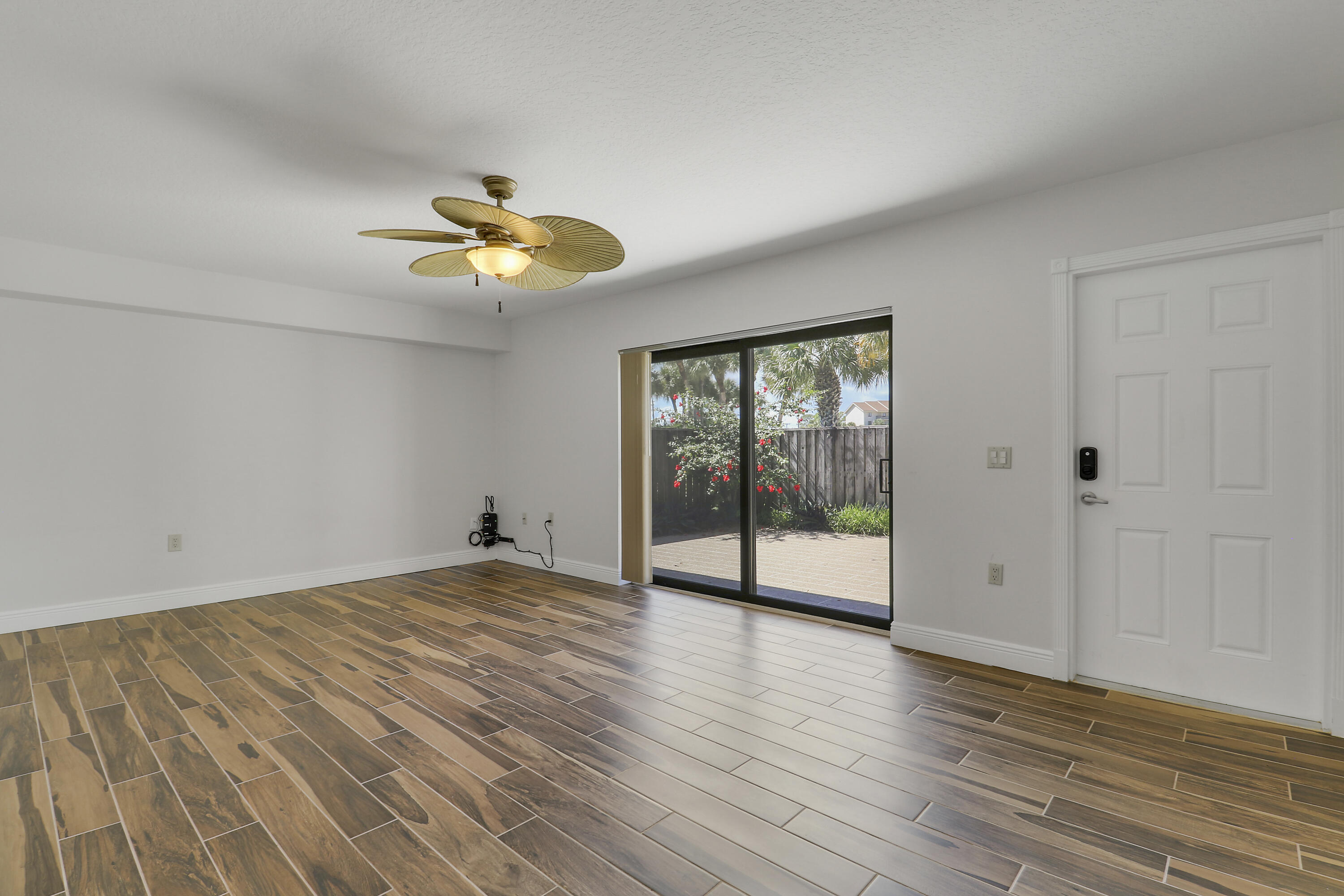 2324 23rd Court, Unit 55D Jupiter, FL 33477 - Photo 16 of 41 wooden floor in an empty room with a window