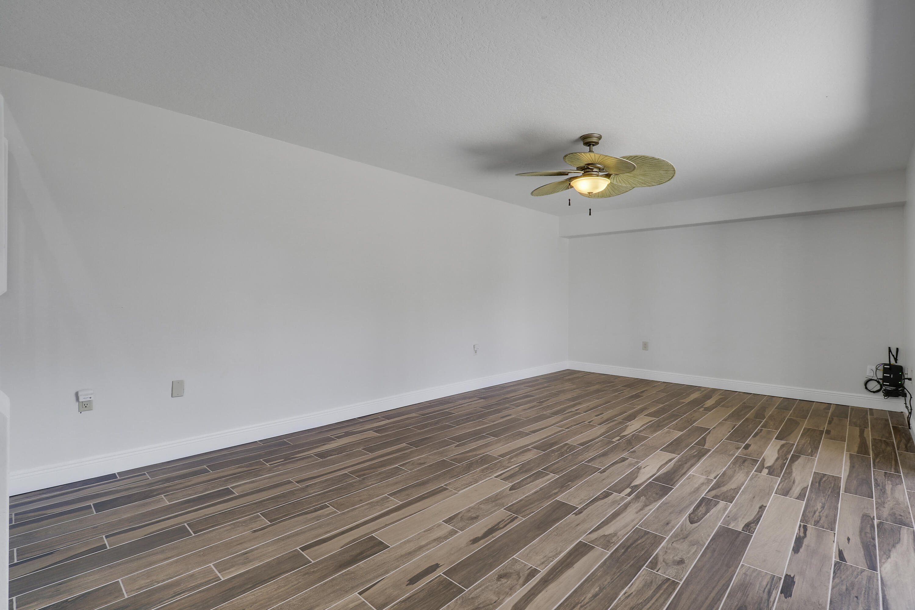 2324 23rd Court, Unit 55D Jupiter, FL 33477 - Photo 21 of 41 a view of an empty room and wooden floor