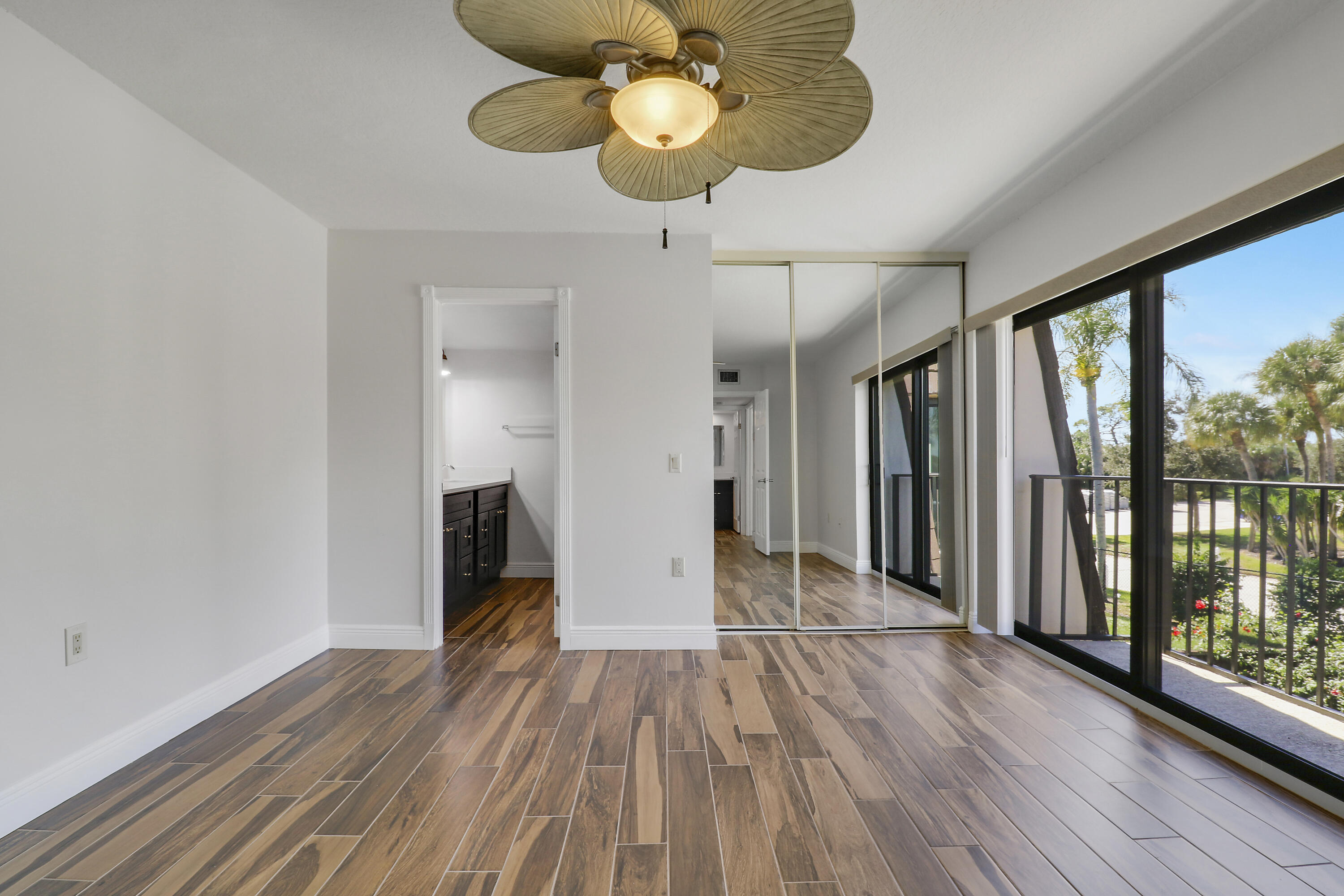 2324 23rd Court, Unit 55D Jupiter, FL 33477 - Photo 23 of 41 a view of a room with wooden floor fan and windows