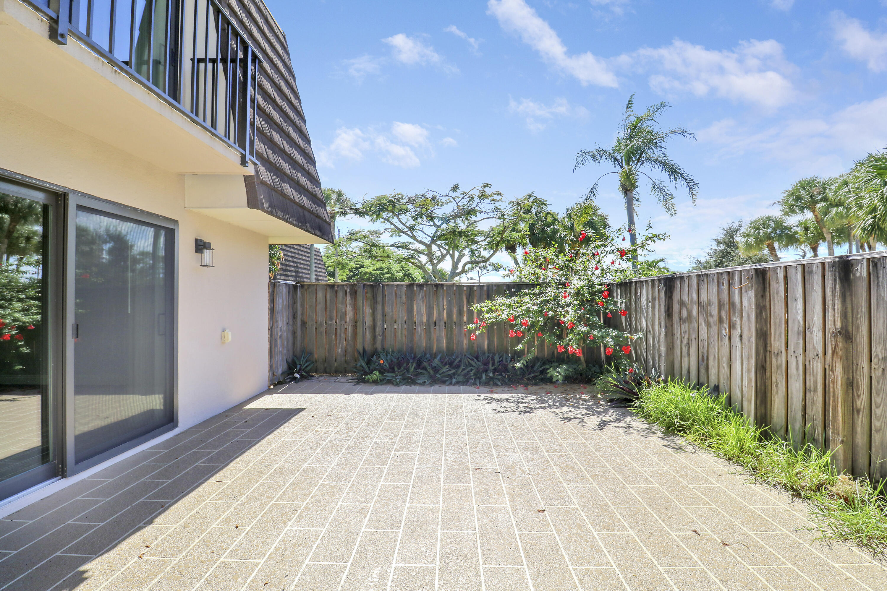 2324 23rd Court, Unit 55D Jupiter, FL 33477 - Photo 35 of 41 a backyard of a house with lots of green space
