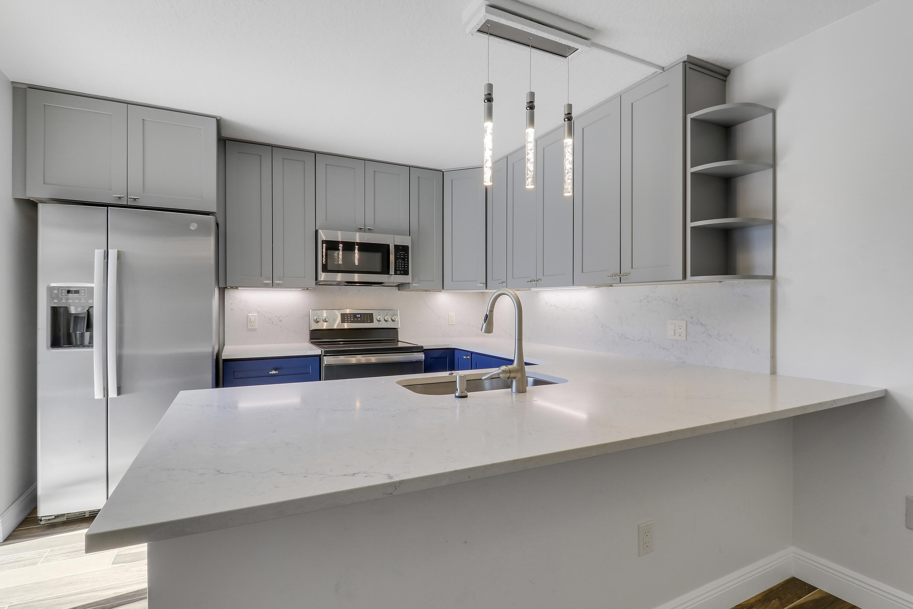 2324 23rd Court, Unit 55D Jupiter, FL 33477 - Photo 6 of 41 a kitchen with a refrigerator and a sink