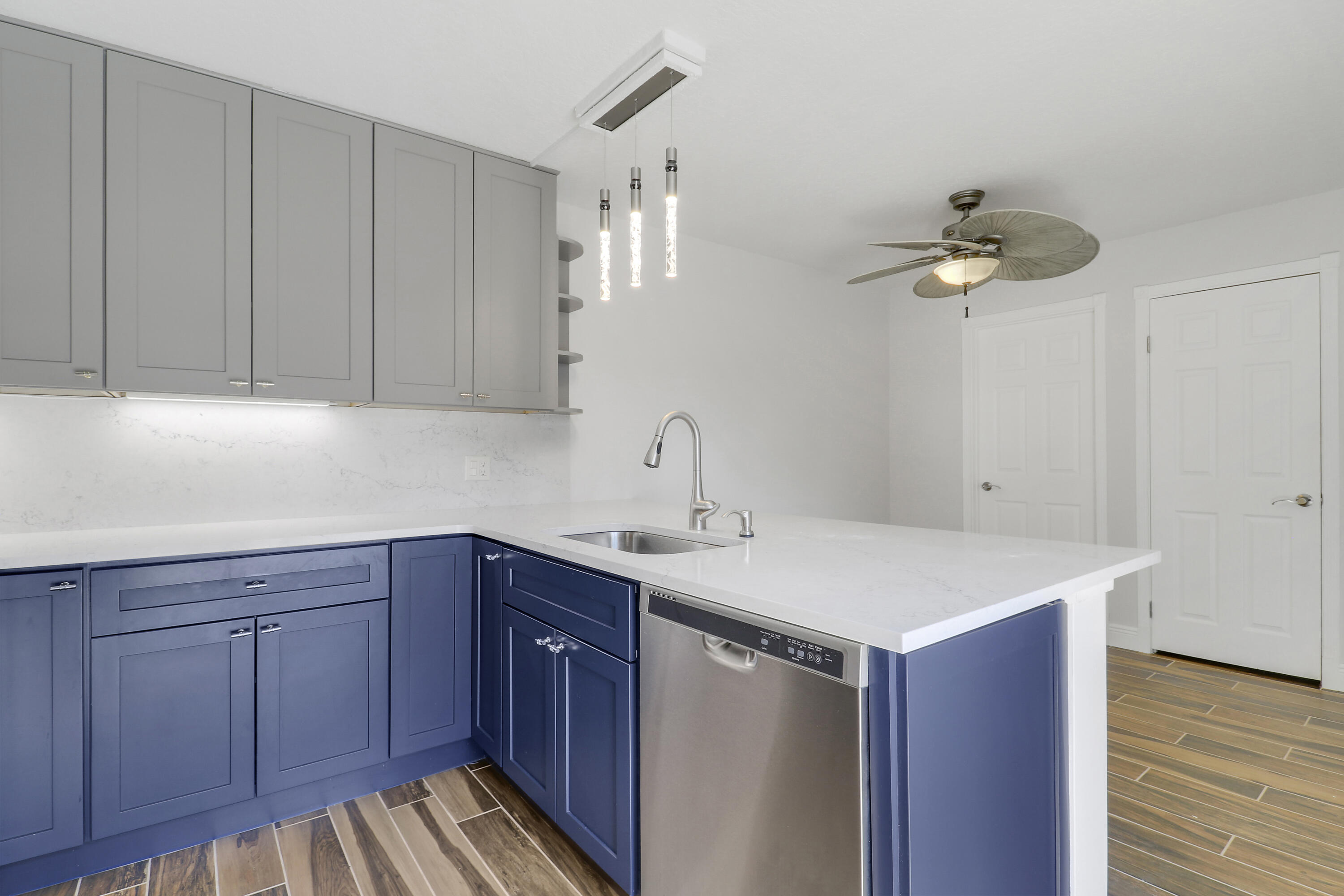 2324 23rd Court, Unit 55D Jupiter, FL 33477 - Photo 10 of 41 a kitchen with a sink cabinets and wooden floor