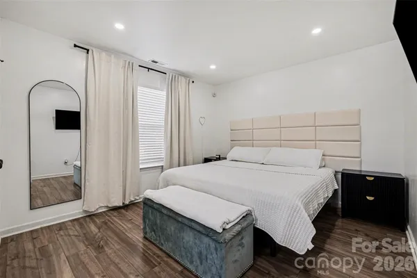 a spacious bedroom with a bed and a shower
