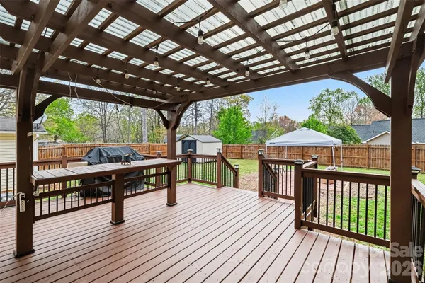 a view of a wooden deck with a yard