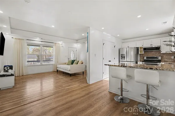 a kitchen with kitchen island a counter top space cabinets and stainless steel appliances