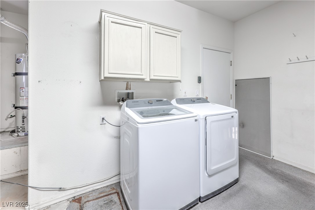 2404 Spring Water Drive Las Vegas, NV 89134 - Photo 20 of 27 Laundry area featuring cabinet space, washer and dryer, and strapped water heater